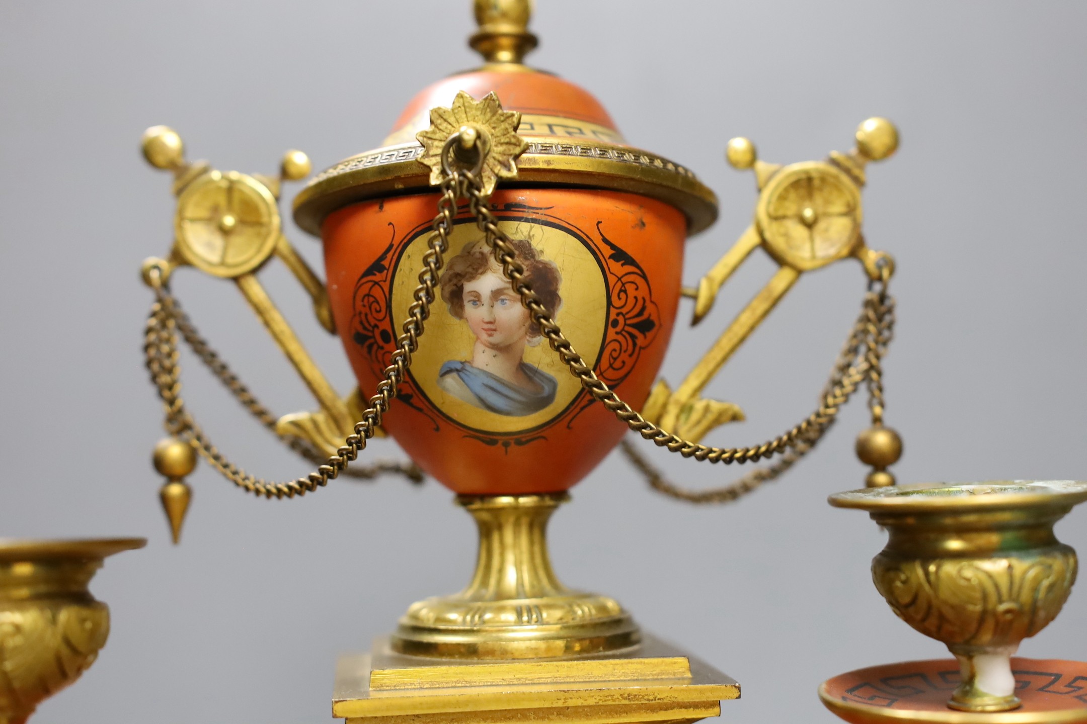 A late 19th century French Etruscan revival ormolu and porcelain mounted three piece clock garniture, 40cm